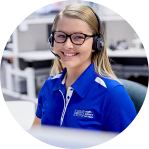 woman wearing glasses and a bright blue polo shirt smiling to camera with a headset on