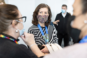 Two women wearing face masks looking at each other