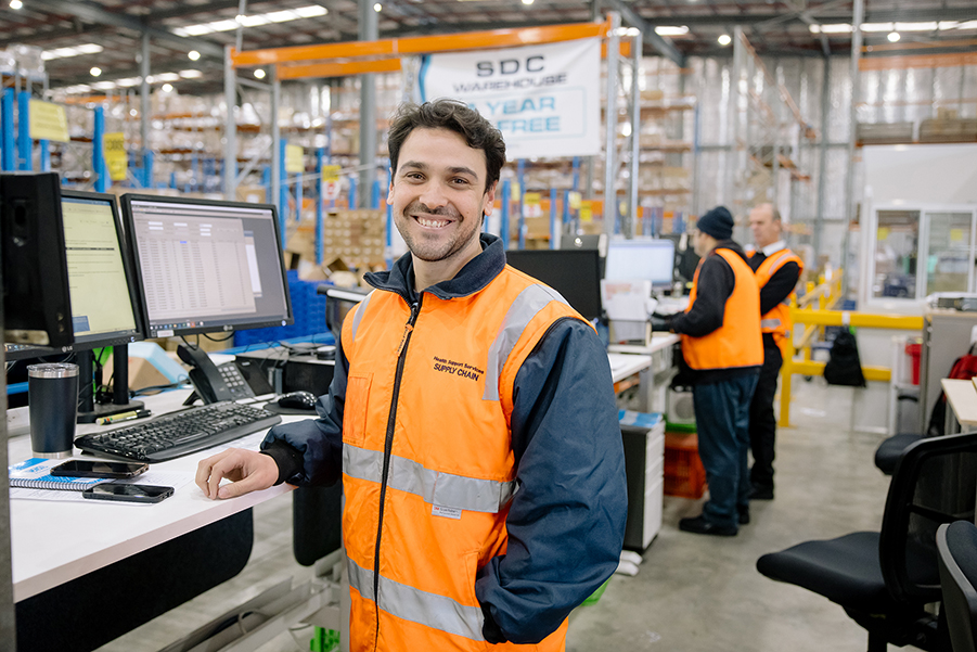 Man stands in front of warehouse desk