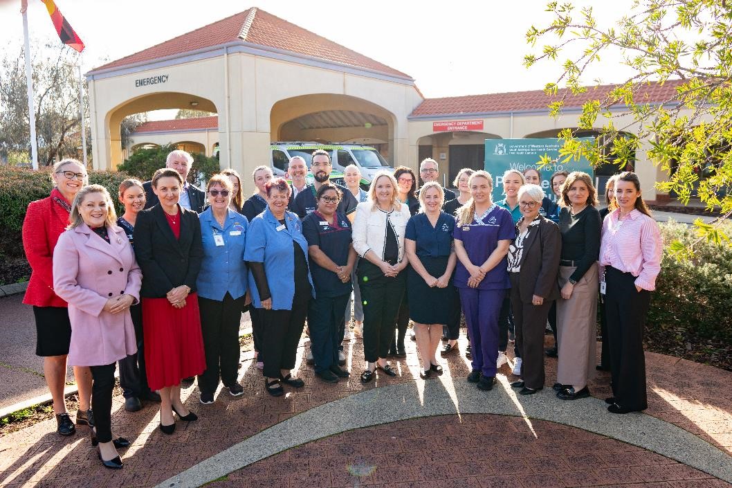 Group of people standing in front of an emergency department of a hospital