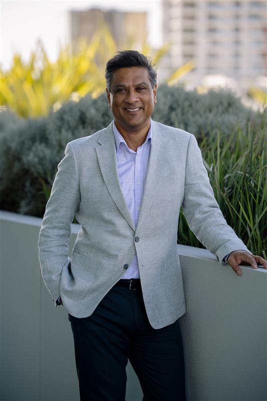 Person standing with one hand in pocket